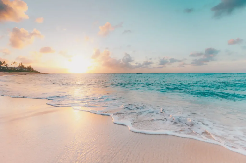 Relaxing tropical ocean sunrise with clear blue water and soft sandy beach