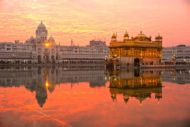 Golden Temple Amritsar glowing at sunrise with reflection in the holy Sarovar tank